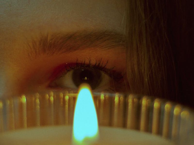 Close up of eyes reflecting soft natural light during meditation.