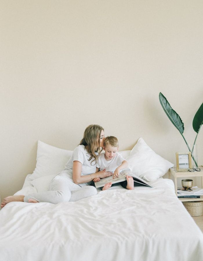 Woman performing visual relaxation exercises in a minimalist dark room.